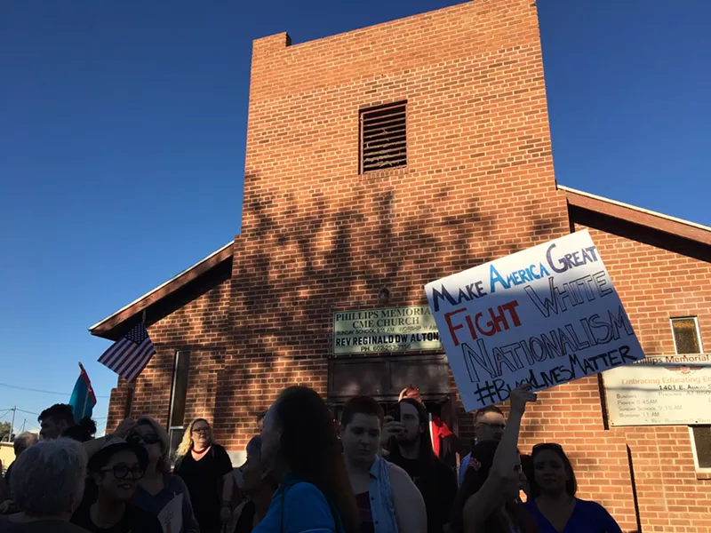 Image: Vigil attendees spilled out of the church and onto the street and sidewalk. Hundreds came out to condemn the white supremacist rally in Virginia that left three people dead.