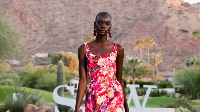 A Black model posing in front of a mountain.