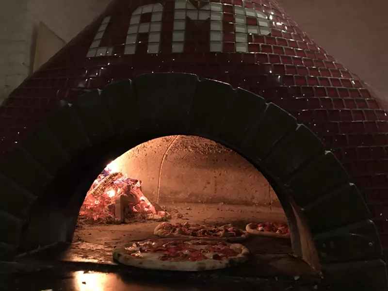 Image: The LAMP red brick oven is like a lighthouse in the restaurant.