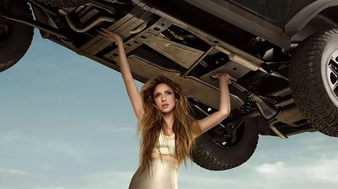 A woman holding up a car.