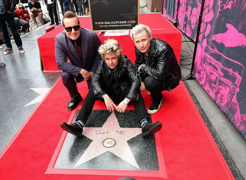 Image: Tré Cool, Billie Joe Armstrong and Mike Dirnt of Green Day pose with their star during their Hollywood Walk of Fame Star Ceremony on May 01, 2025, in Hollywood, California.