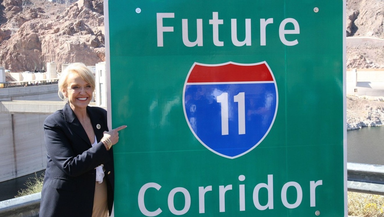 Former Governor Jan Brewer unveils new signs at a March 2014 ceremony at Hoover Dam, after Congress designated the future Interstate 11 route