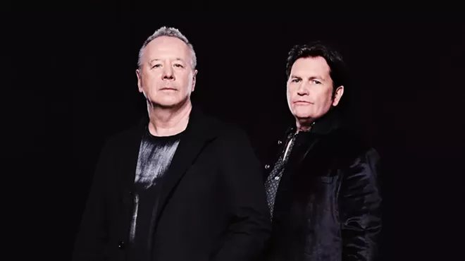 Two band members pose for picture.