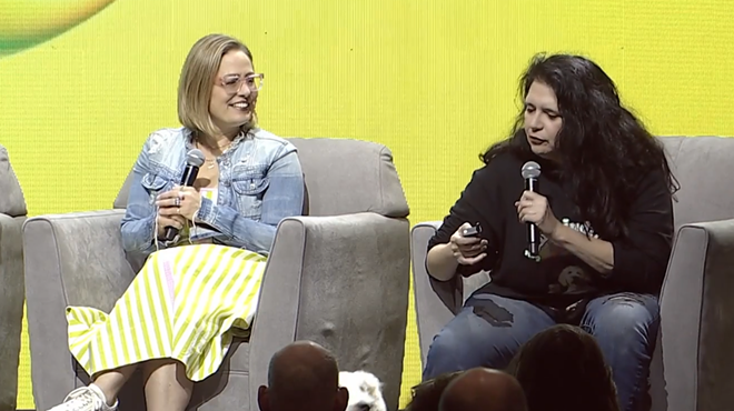 kyrsten sinema and sue sisley on a stage