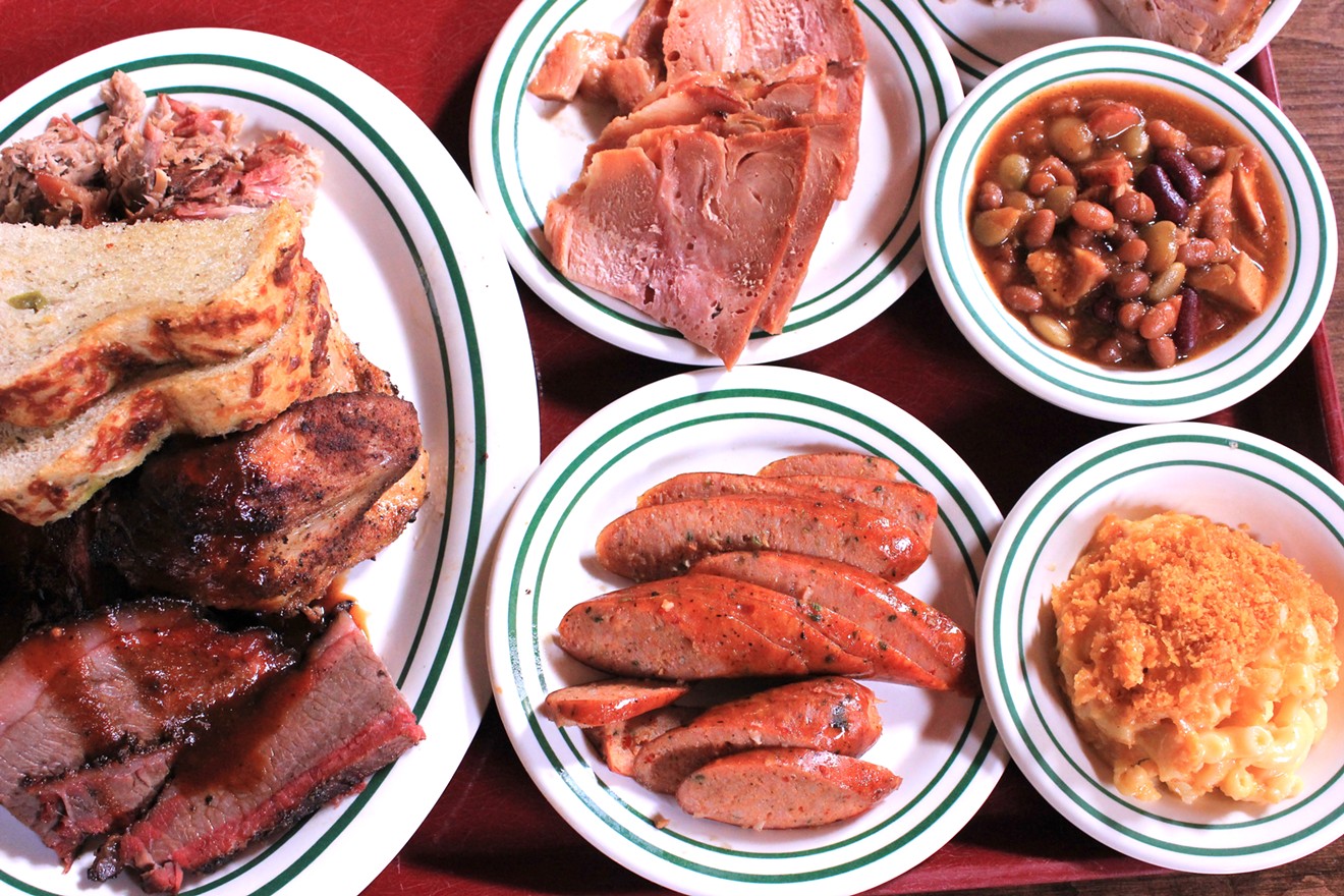 A meat platter with meat add-ons and sides