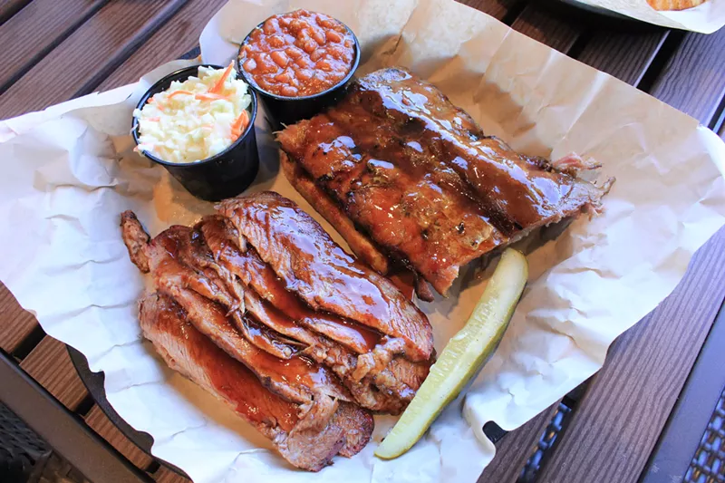 Image: Ribs and brisket smoked over almond wood in West Alley's concrete pit
