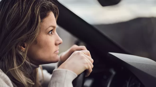 a woman staring intently out of her car