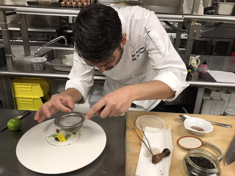 Image: Ryan Swanson, head chef at Kai, sieves sumac-willow dust onto meringue.
