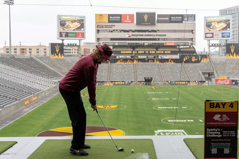 Image: Parker O’Kelly, a student at Arizona State University, hits a golf ball at the Sparky’s Fairway event at Mountain America Stadium.