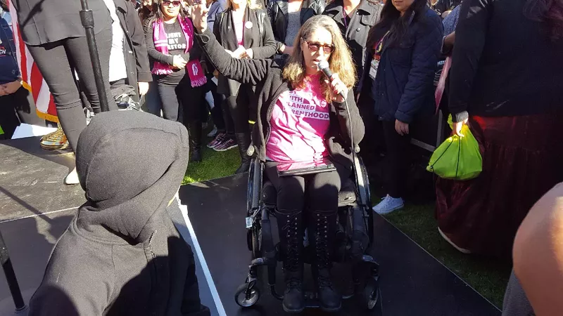 Image: Jennifer Longdon spoke at the women's march in Phoenix on January 21 — from the ground — while the rest of the event's speakers took the stage.