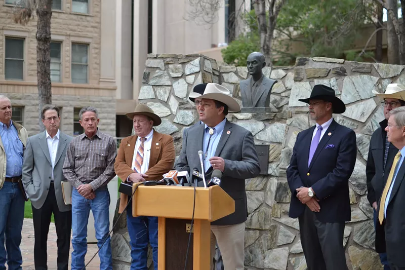 Image: Arizona State Representative David Cook, center, at a press conference outside the Arizona Capitol in 2019.
