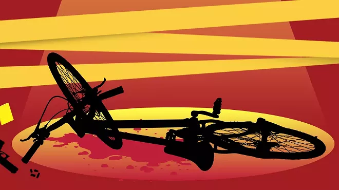 a illustrated silhouette of a bike on the ground with blood around it, under a spotlight