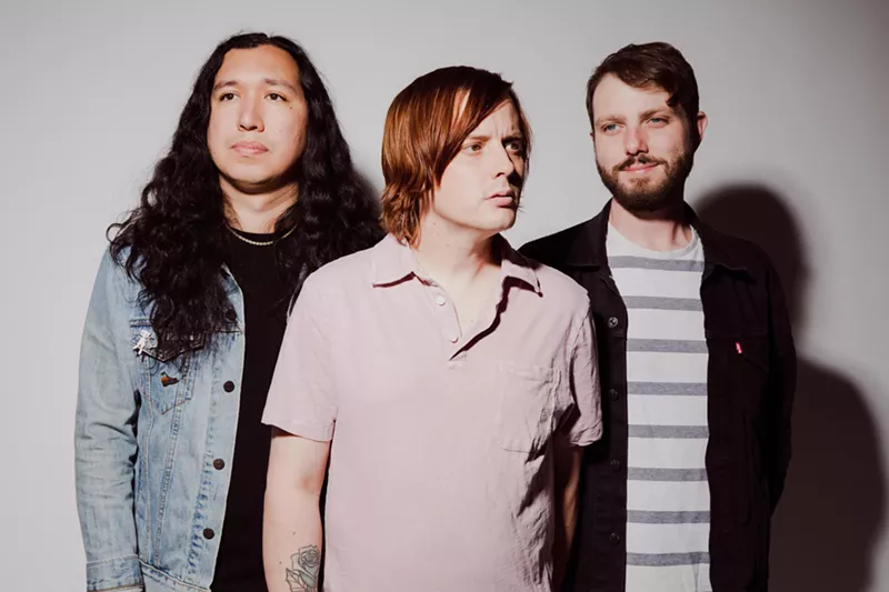 Image: Sundressed frontman Trevor Hedges (middle) is flanked by bandmates Justin Portillo (left) and AJ Peacox.