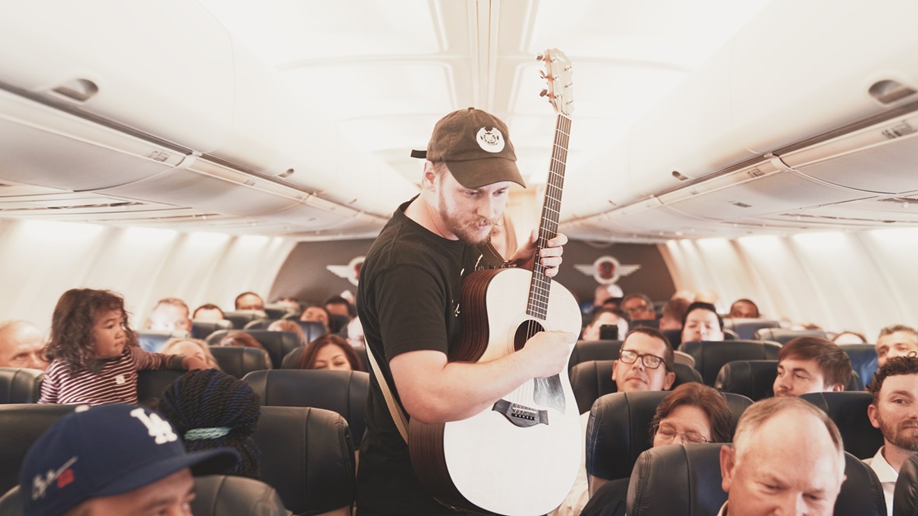 Forrest Waldorf from Sundressed walks into the aisle during an in-flight performance from El Paso to Dallas.