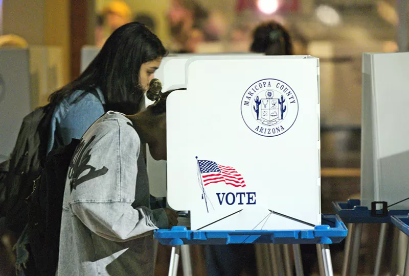 Image: Someone in a Maricopa County voting booth