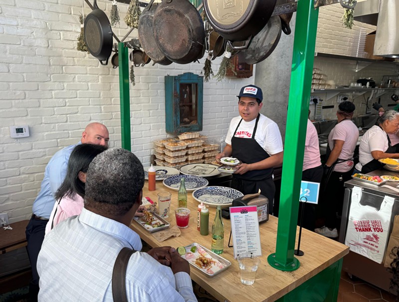Chef and co-owner Suny Santana delivers food to guests at the chef's table at Taco Chelo in Tempe. The intimate table also offers a front-row view into the kitchen.