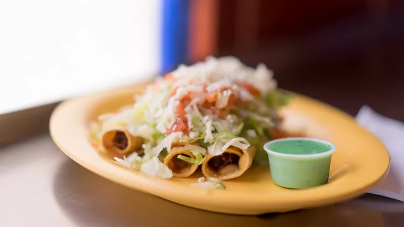Image: At Taquitos Jalisco, taquitos are always served under a salad-sized portion of lettuce and shredded cheese. As for the dipping, you’ll notice a condiment unlike any other you’ve seen — a bright green, creamy sauce made from tomatillos, jalapeños, and avocado.