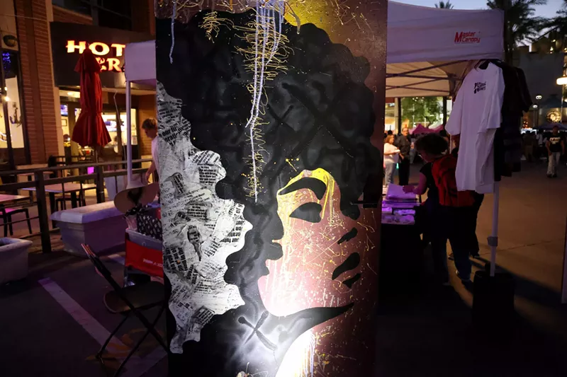 Image: The door that represents the future in The Doorways installation has a graffiti-style background and a silhouette of a Black woman with an Afro. Photo taken at the Juneteenth Block Party on June 15 in Tempe.