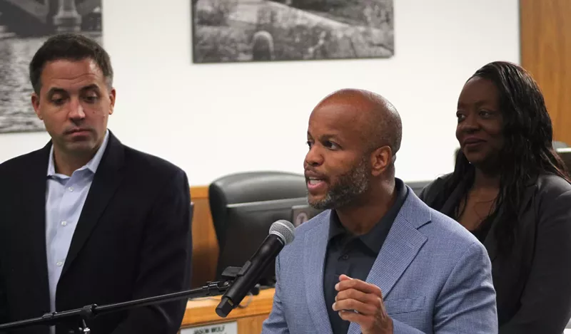 Image: corey woods speaks at a microphone