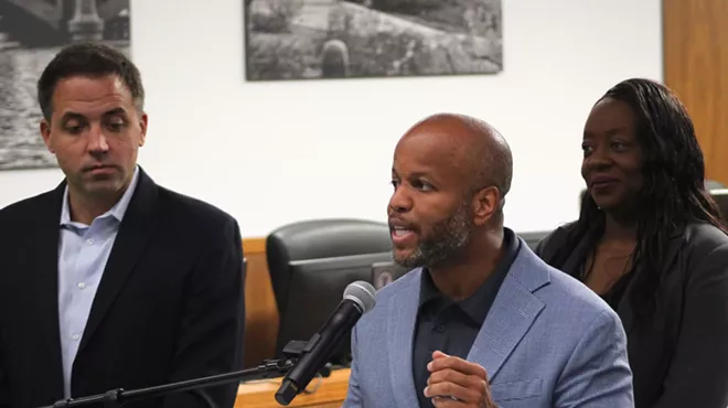 corey woods speaks at a microphone