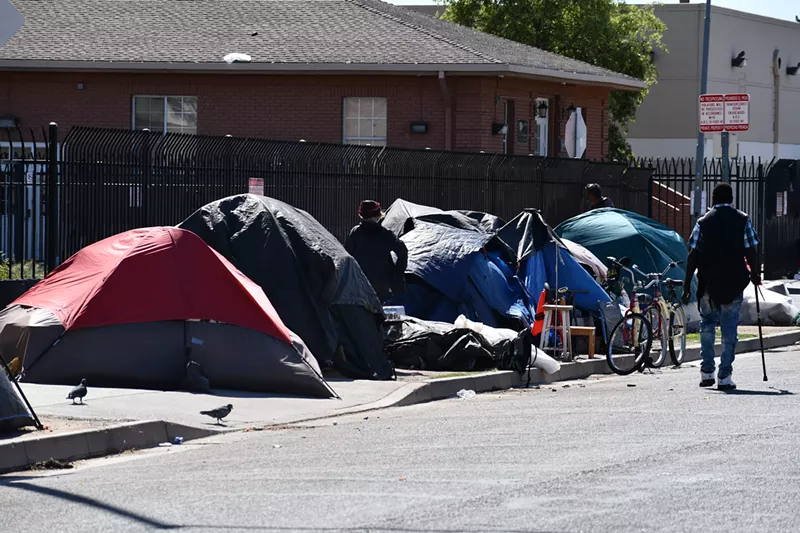 Image: Homeless people live in tents along Madison Street