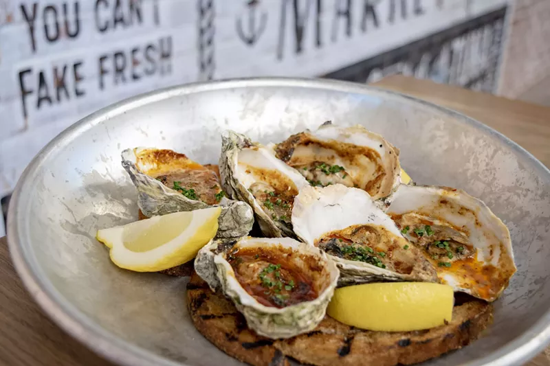 Image: Grilled oysters from Chula Seafood Uptown are finished with bourbon-chipotle butter.