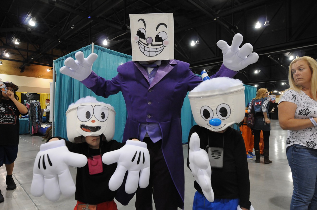 A family cosplaying Cuphead.