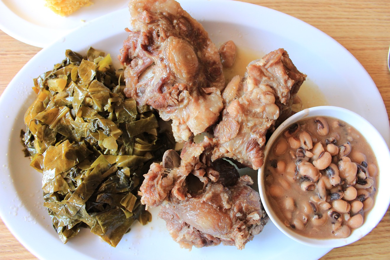 Stewed oxtail flanked by collards and a bowl of black eyed peas, from Mrs. White's Golden Rule Cafe.
