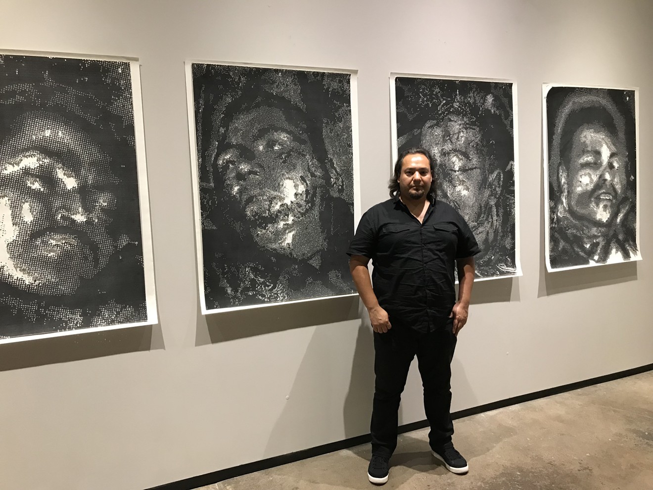 Miguel A. Aragón with some of his work at Northlight Gallery.