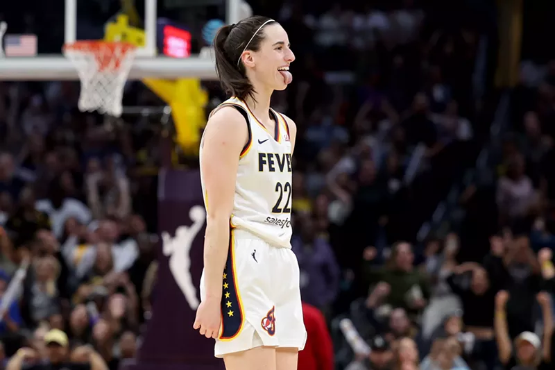 Image: Caitlin Clark sticking her tongue out on a basketball court