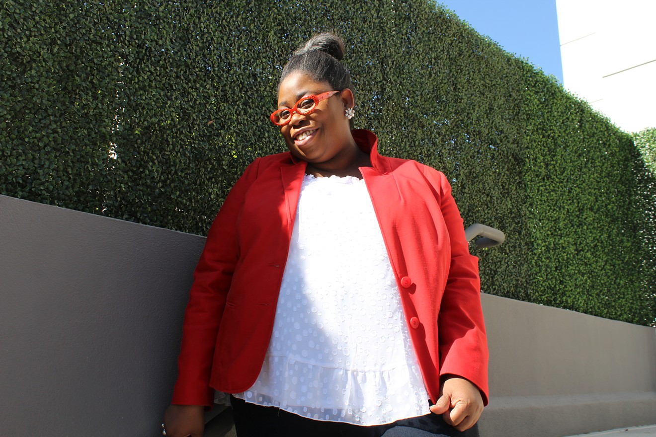 Mignon Gould founded her style spotting website, The Chic Spy, in 2007 and Chic Spy Day in 2015. Today she's wearing a Nordstrom ruffled top, the Modernist blazer by Lane Bryant, and Melissa McCarthy Seven7 crop jeans.