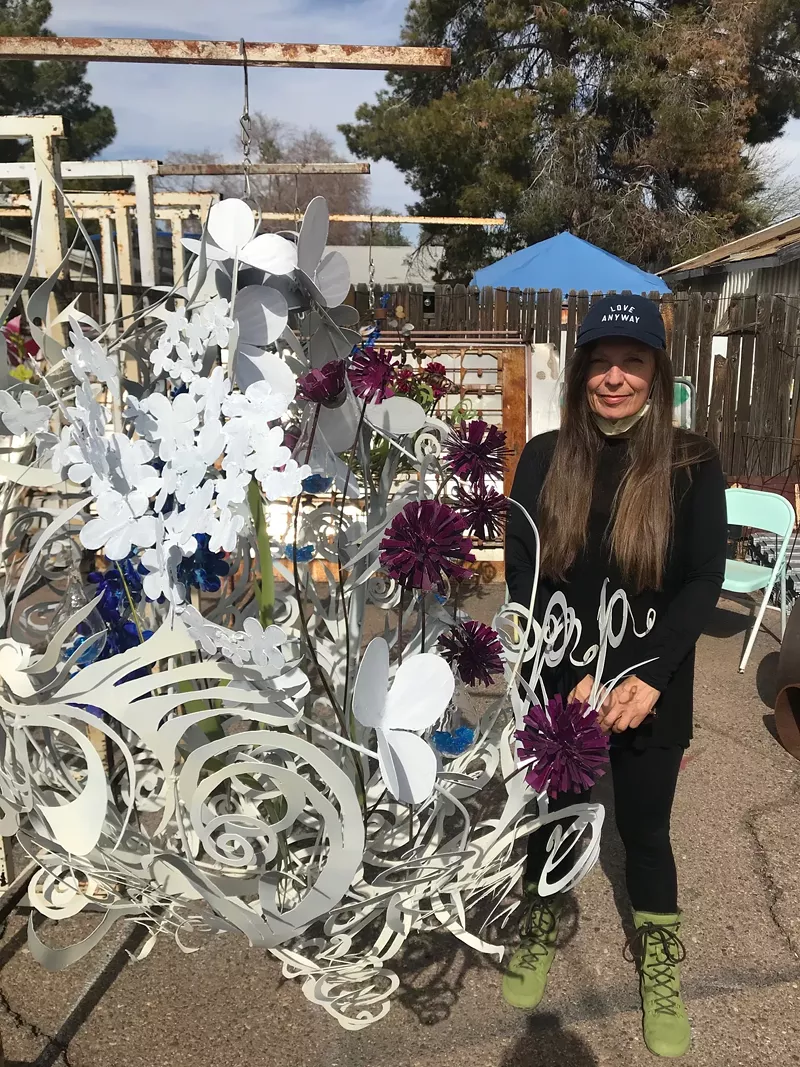 Image: Ceri Jones, artist and owner of The Collaboratory, stands by one of her light fixtures.