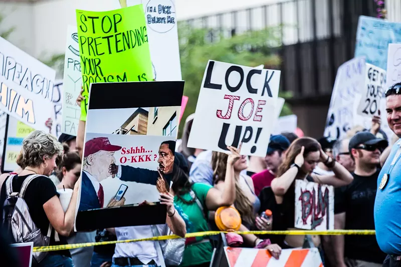 Image: Protesters made it clear they weren't in favor of a pardon for Joe Arpaio during President Trump's visit to Phoenix.