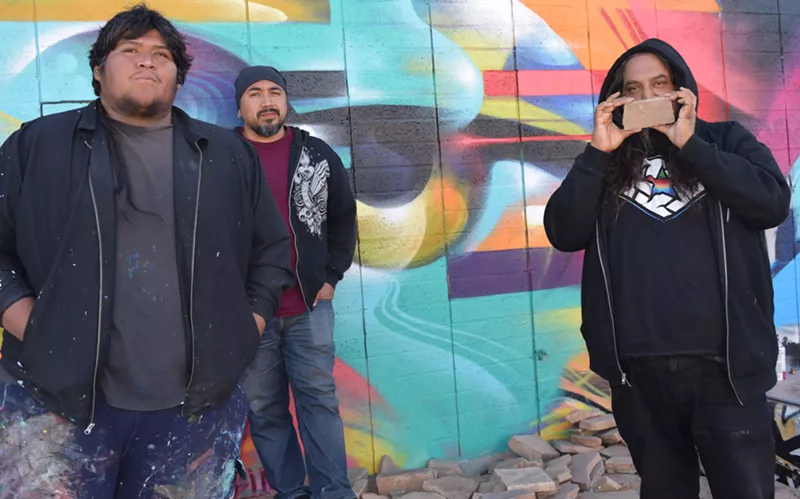 Image: NeoGlyphix artists Dwayne Manuel, Thomas "Breeze" Marcus, and Vyal while working on the Hive mural.