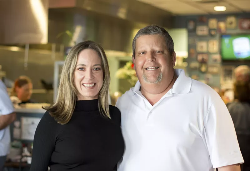 Image: Jennifer Caraway and Mike La Brasca stand in The Joy Bus Diner. La Brasca volunteers for the organization founded by Caraway, delivering meals to homebound cancer patients once a week.
