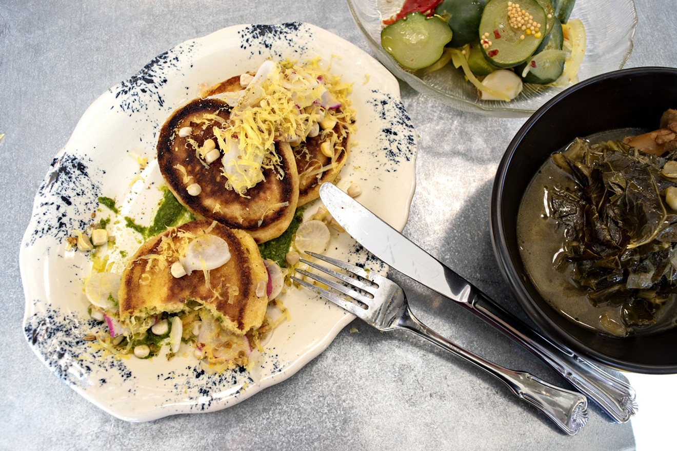 Hoecakes, old-time savory cornbread pancakes, are a staple at Larder + Delta as are the pickles and braised greens.