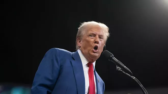 Donald Trump speaking into a microphone
