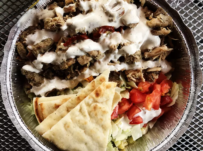 Image: The white and hot sauces make the combo platter at the Halal Guys.