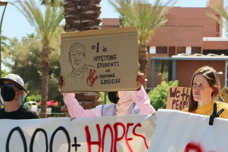 Image: People holding signs at a protest.