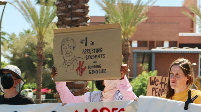 People holding signs at a protest.