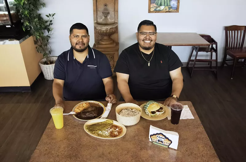 Image: Two men at a table.