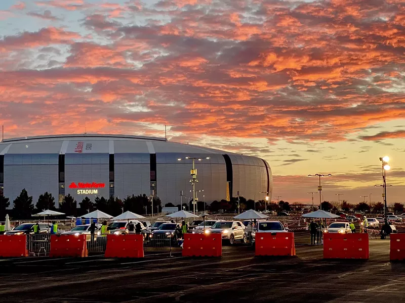 Image: People line up to receive vaccines at State Farm Stadium.