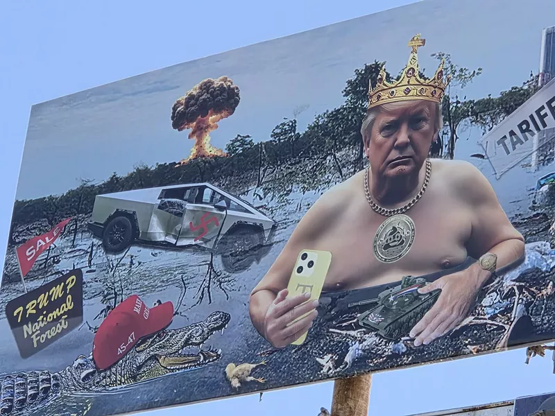Image: a close-up of a billboard showing donald trump shirtless wearing a crown in a swamp