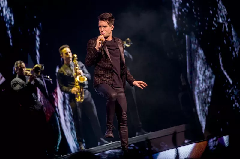 Image: Brendon Urie croons into the mic at Panic! at the Disco's 2018 show at Glendale's Gila River Arena.