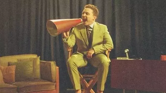 A man sitting in a director's chair.