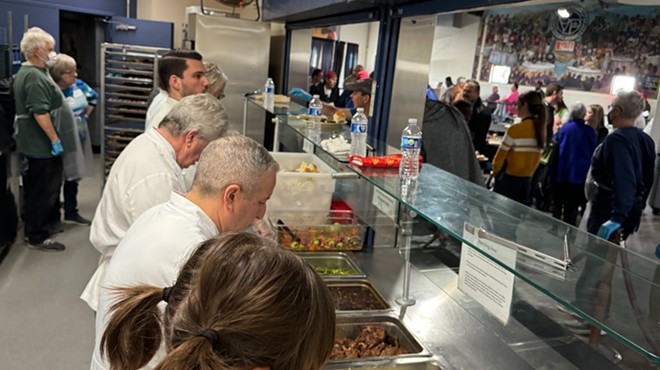 Chefs serve food at St. Vincent de Paul.