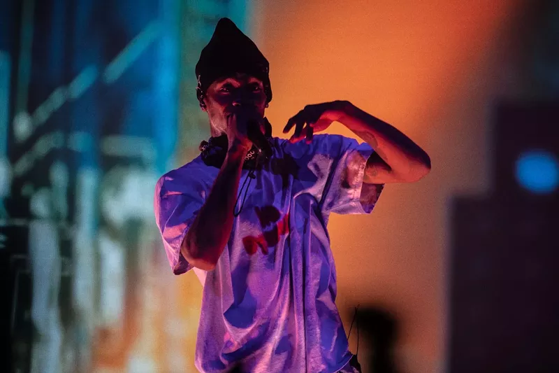 Image: Travis Scott wearing one of his T-shirts while performing at Talking Stick Resort Arena on Tuesday, December 18, 2018.