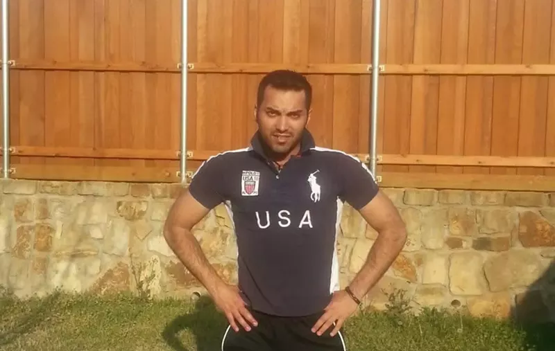 Image: a man in a USA rugby shirt