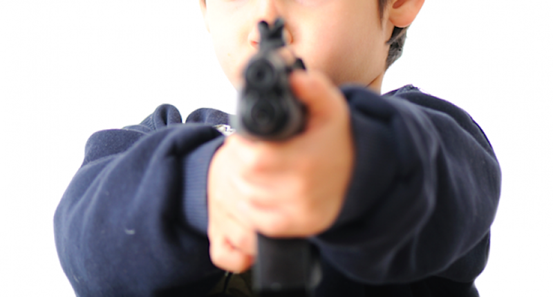 Image: a child pointing a gun