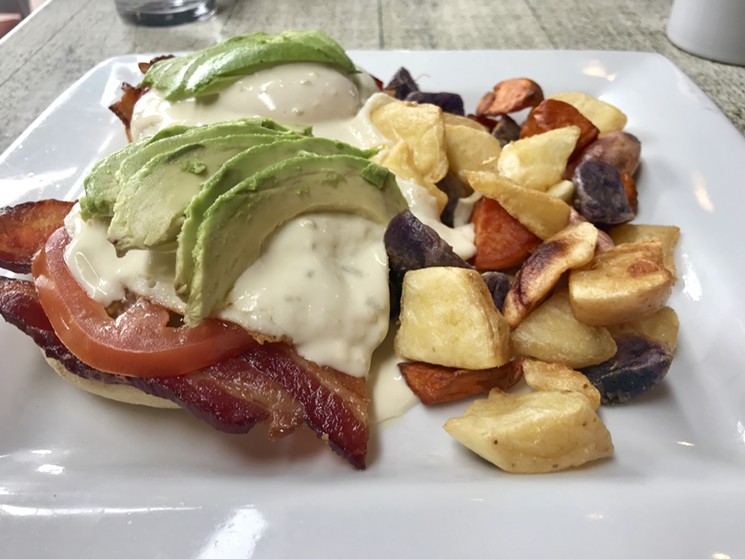 Soul Café's version of an eggs Benedict is "Eggs Jared," English muffins topped with bacon, tomatoes, eggs, and a jalapeño cheese sauce, served with roasted potatoes (avocado optional). - MELISSA CAMPANA